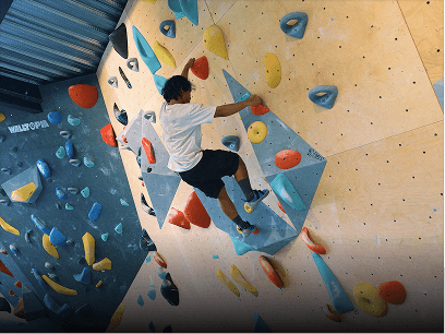 A climber on a bouldering wall